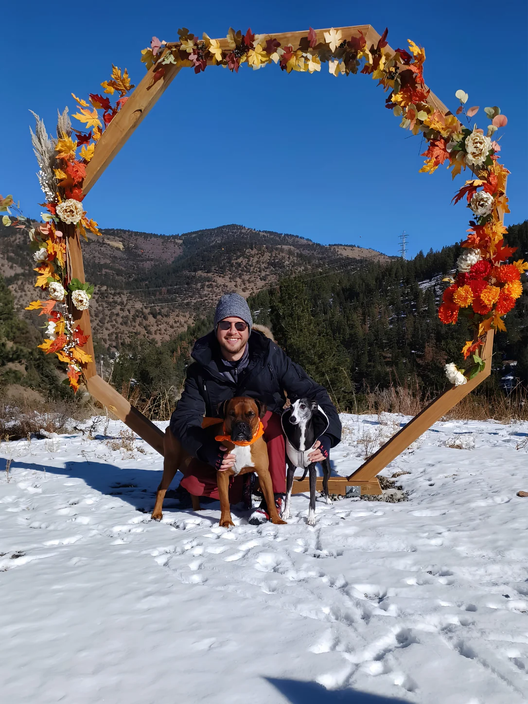 Rizzi outdoors in the Colorado mountains with two dogs